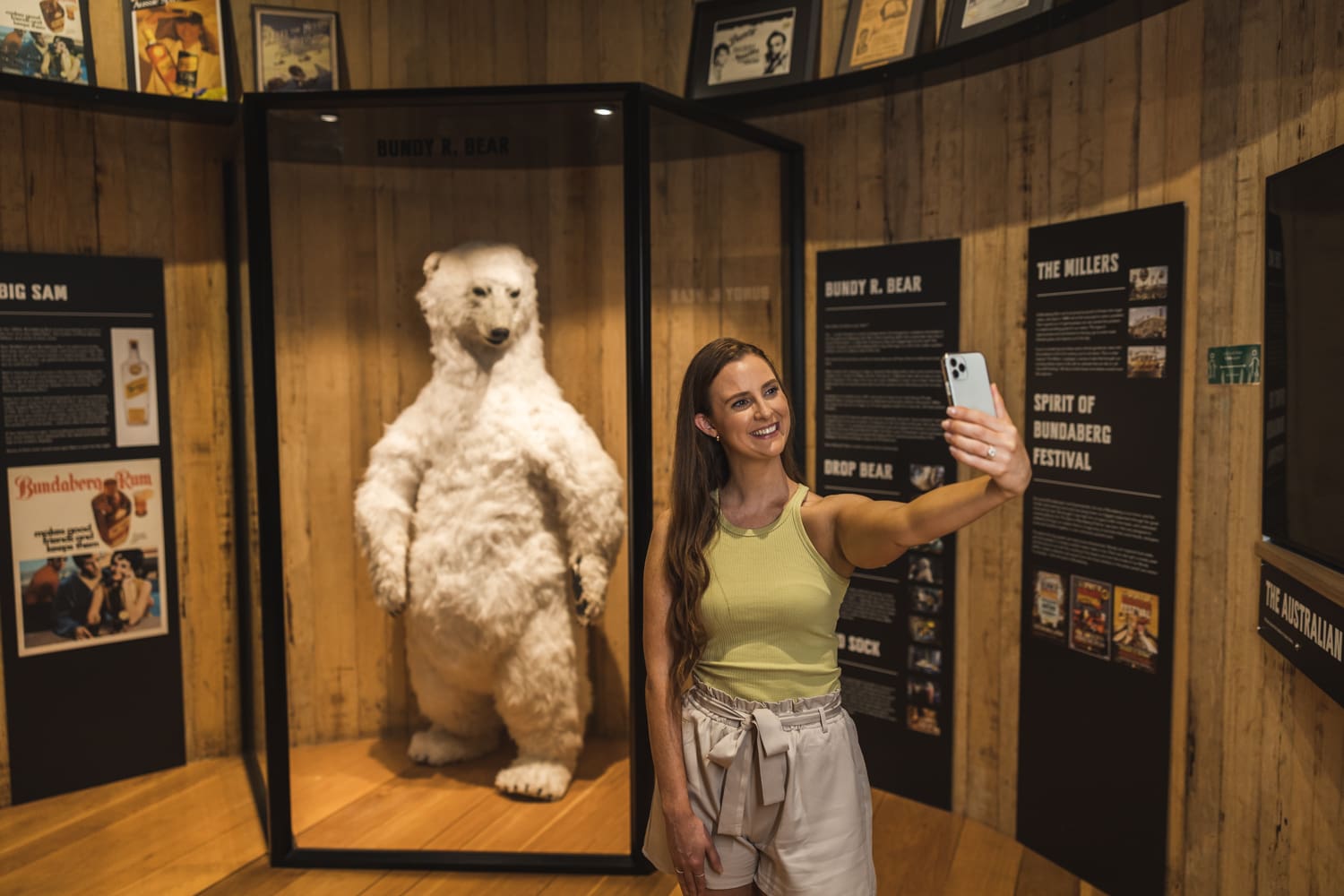 Woman taking selfie with Bundy R Bear at Bundaberg Rum Visitor Experience